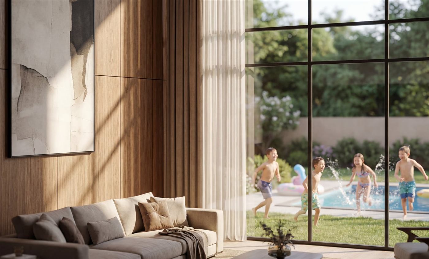 Living room opening onto the garden and pool in a Terraces townhouse